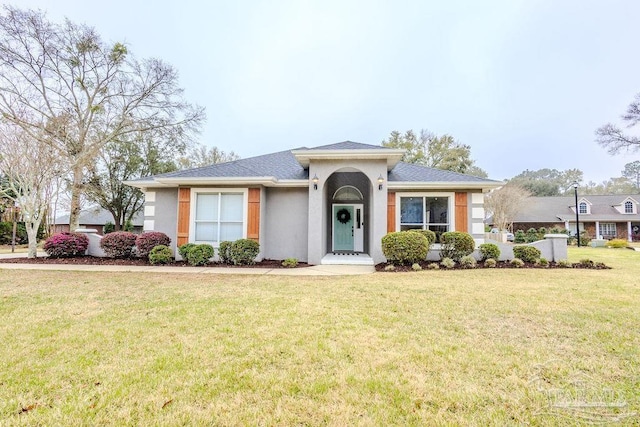 view of front of property with a front yard and stucco siding