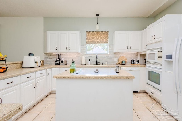 kitchen with white appliances, light tile patterned flooring, light countertops, and tasteful backsplash