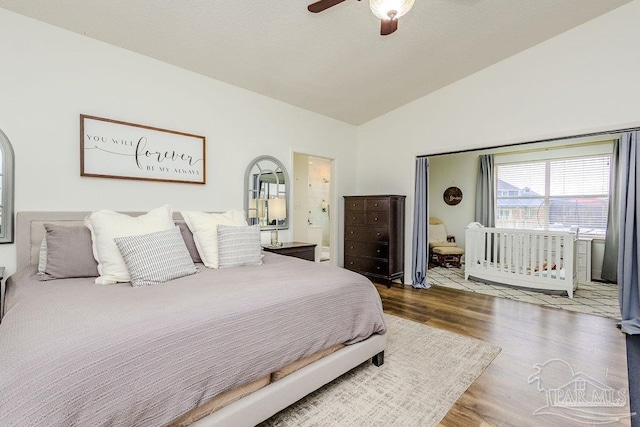 bedroom with a ceiling fan, lofted ceiling, and wood finished floors