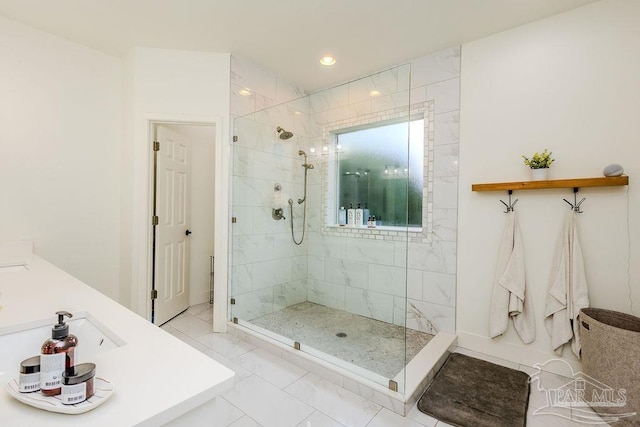 full bathroom with recessed lighting, marble finish floor, a stall shower, and a sink