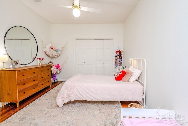 bedroom featuring a closet, a ceiling fan, and wood finished floors