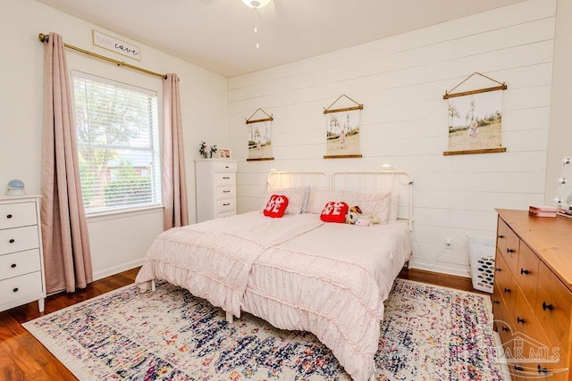 bedroom featuring wood finished floors and baseboards