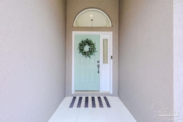 doorway to property with stucco siding