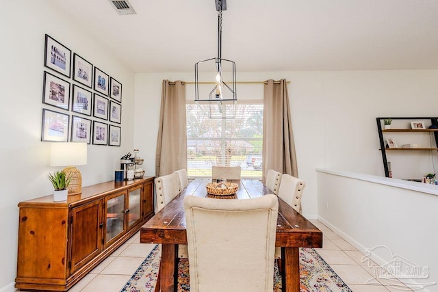 dining room with light tile patterned flooring, baseboards, and visible vents