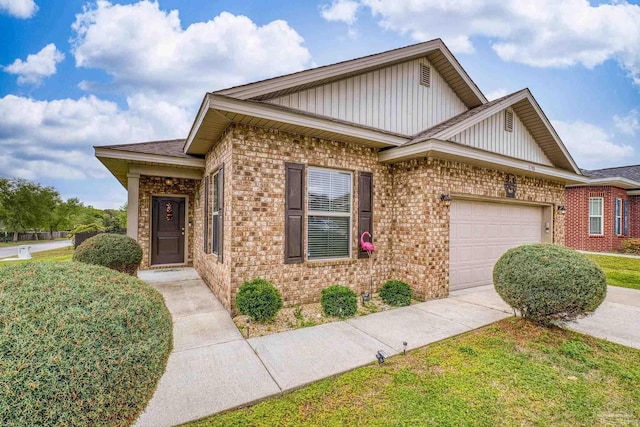 5798 Vendome Ct, Milton, FL 32583 - view of front of property with an attached garage, concrete driveway, board and batten siding, and brick siding