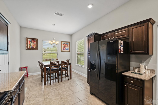 5798 Vendome Ct, Milton, FL 32583 - kitchen with a notable chandelier, visible vents, light stone countertops, dark brown cabinetry, and black appliances
