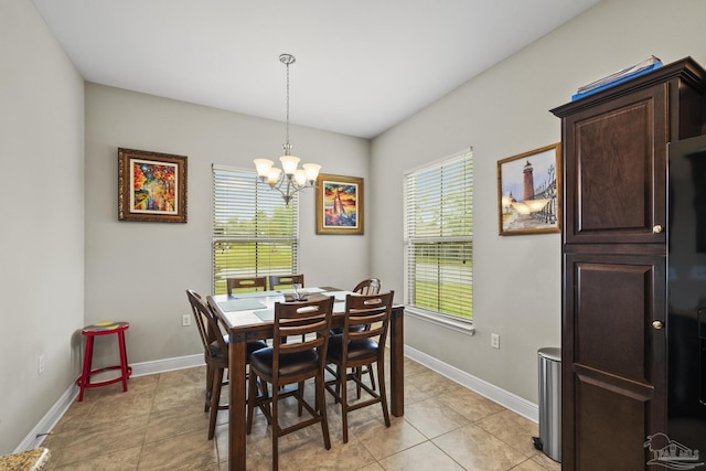 5798 Vendome Ct, Milton, FL 32583 - dining space with baseboards, an inviting chandelier, and light tile patterned floors