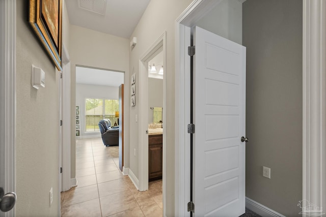 5798 Vendome Ct, Milton, FL 32583 - hall with light tile patterned flooring, baseboards, and visible vents