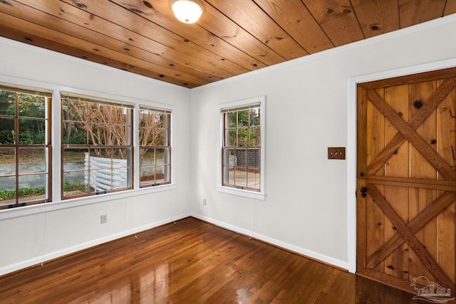 interior space with wood ceiling, ornamental molding, and hardwood / wood-style floors