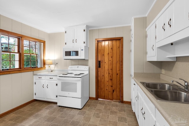 kitchen with crown molding, white appliances, sink, and white cabinets