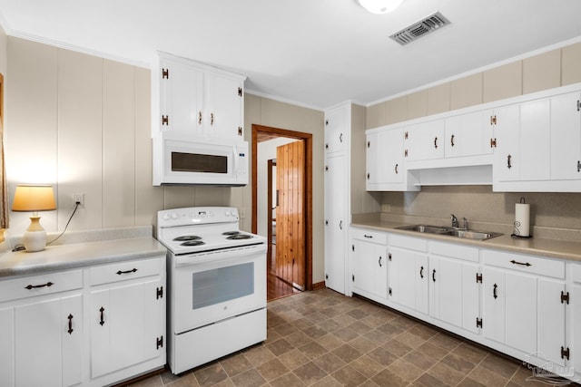 kitchen with white appliances, ornamental molding, sink, and white cabinets