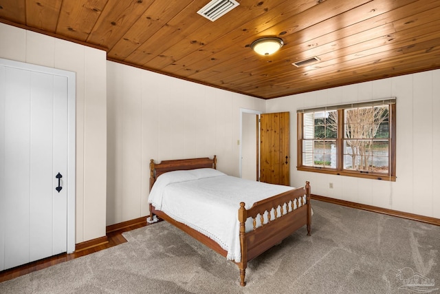 carpeted bedroom with crown molding and wood ceiling