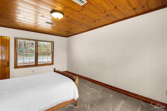 carpeted bedroom with ornamental molding and wooden ceiling