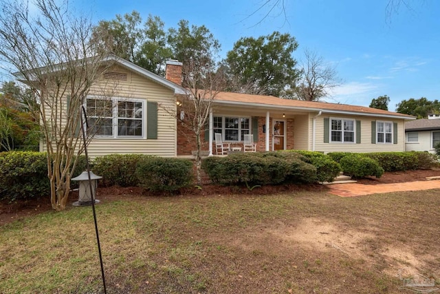 single story home featuring a front yard and covered porch