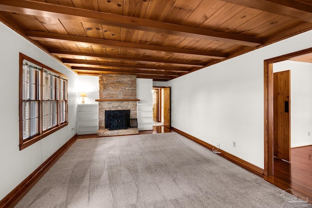 unfurnished living room featuring wood ceiling, carpet flooring, a fireplace, and beamed ceiling