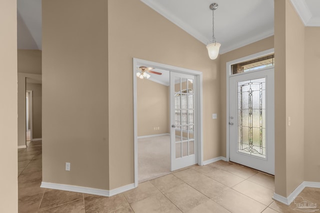 entrance foyer with ornamental molding, french doors, and light tile patterned flooring