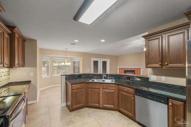 kitchen featuring light tile patterned flooring, appliances with stainless steel finishes, sink, decorative backsplash, and dark stone counters