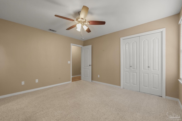 unfurnished bedroom featuring a closet, ceiling fan, and carpet