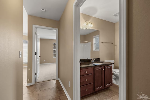 bathroom with vanity, toilet, and tile patterned flooring