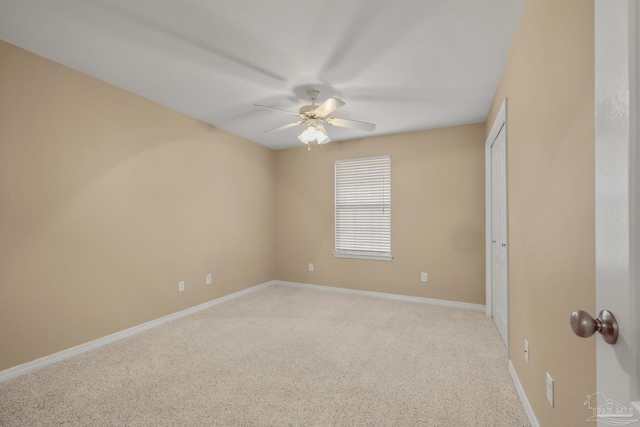 unfurnished room featuring light colored carpet and ceiling fan