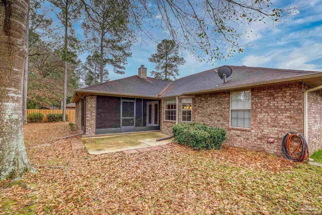 back of house featuring a patio and a sunroom