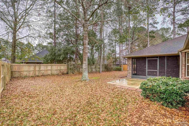 view of yard featuring a patio area and a sunroom