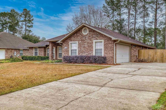 single story home with a garage and a front yard