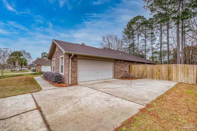 view of property exterior with a garage and a lawn