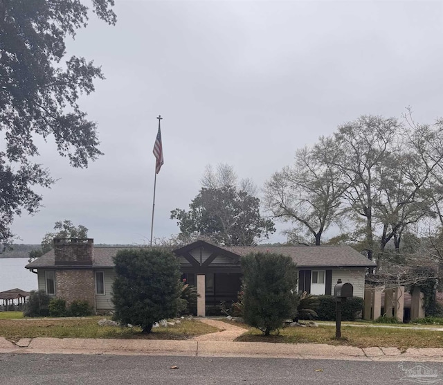 view of front of house featuring a chimney