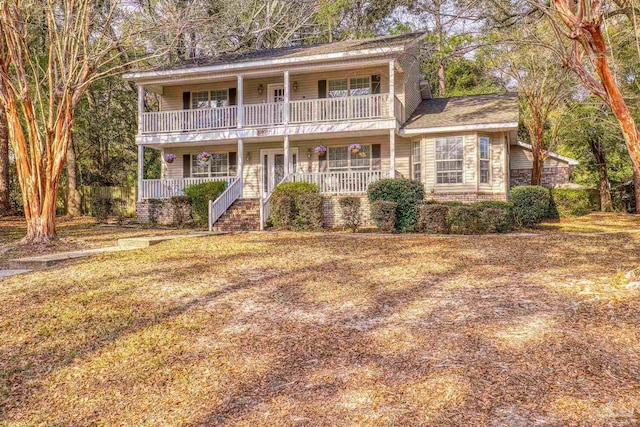 view of property with a porch and a balcony