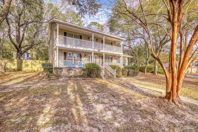 view of front of house with a balcony and covered porch