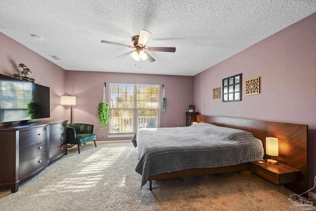 carpeted bedroom with a textured ceiling and ceiling fan