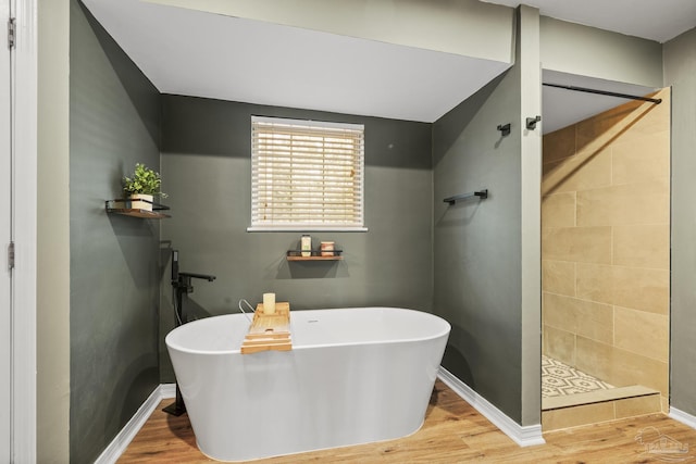 bathroom featuring separate shower and tub and hardwood / wood-style floors