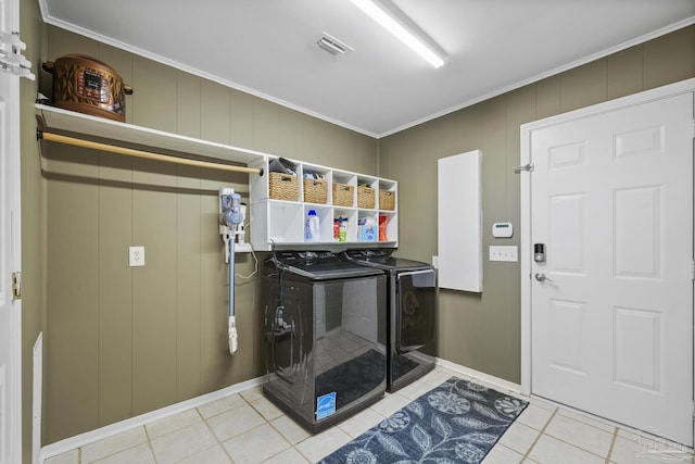 laundry area featuring ornamental molding, tile patterned floors, and separate washer and dryer