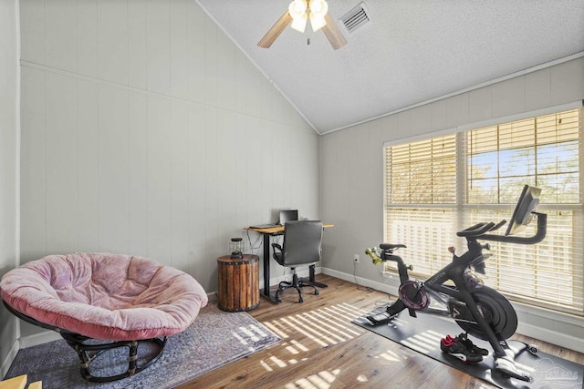 home office with vaulted ceiling, wood-type flooring, and ceiling fan