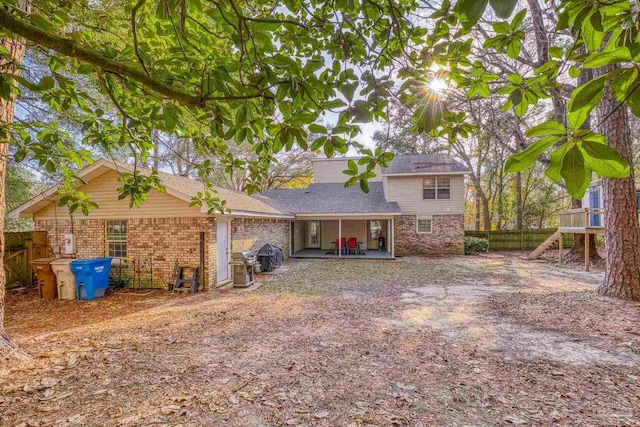 rear view of property featuring a patio area