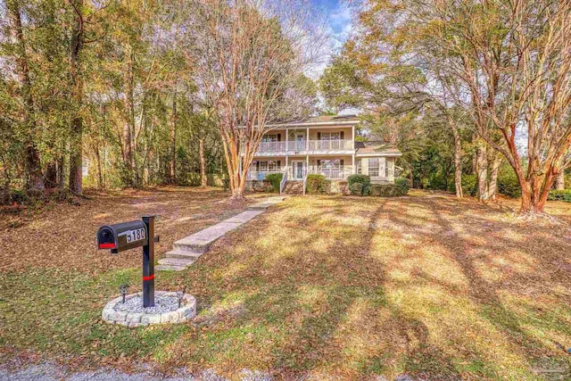 view of front of property featuring a balcony and covered porch