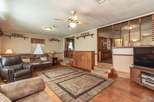 living room featuring hardwood / wood-style flooring and ceiling fan