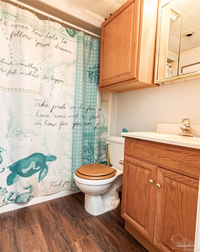 bathroom with hardwood / wood-style floors, vanity, toilet, and ornamental molding