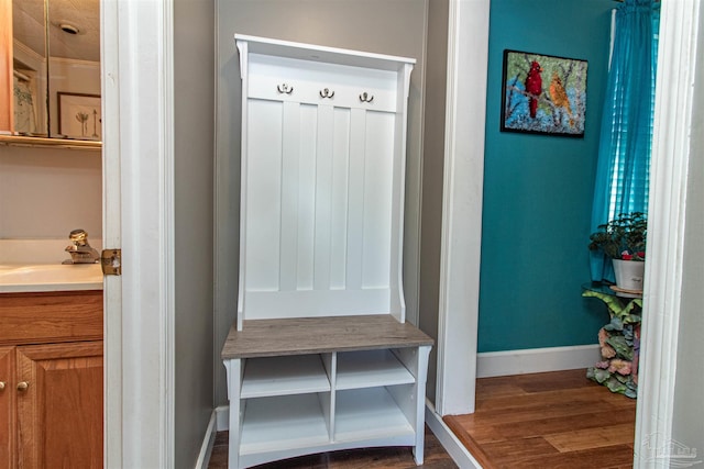 mudroom with dark hardwood / wood-style floors and sink