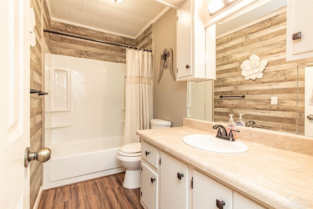 full bathroom featuring ornamental molding, wooden walls, vanity, shower / tub combo, and hardwood / wood-style flooring