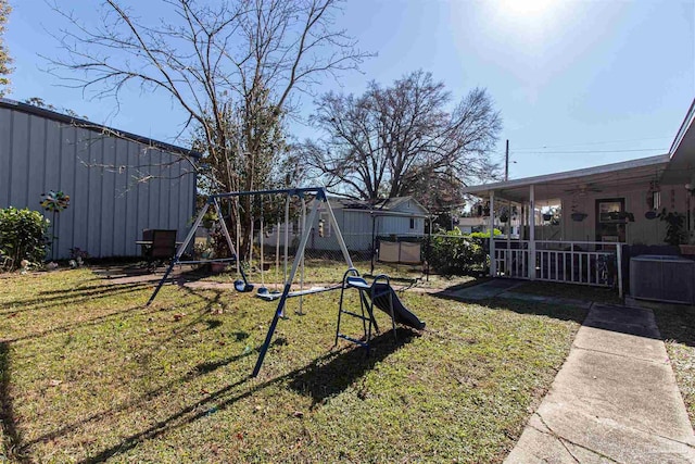 view of yard with a playground and central air condition unit