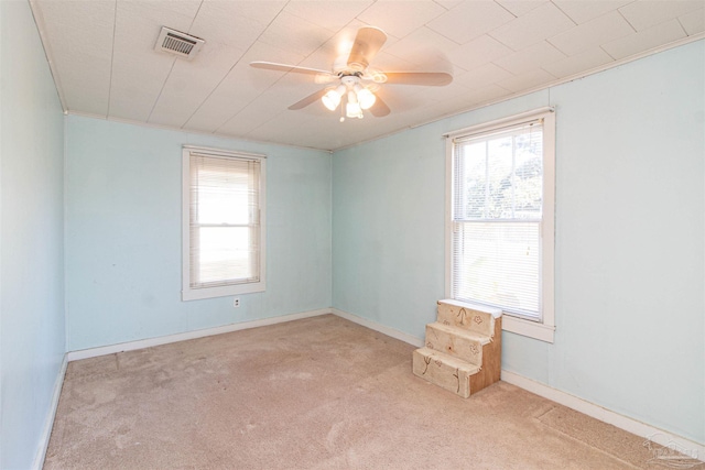 empty room with ceiling fan and light colored carpet