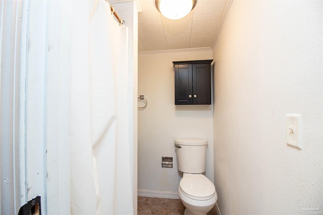 bathroom with crown molding and toilet