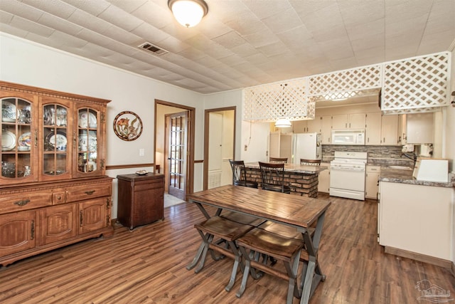 dining area with dark hardwood / wood-style flooring