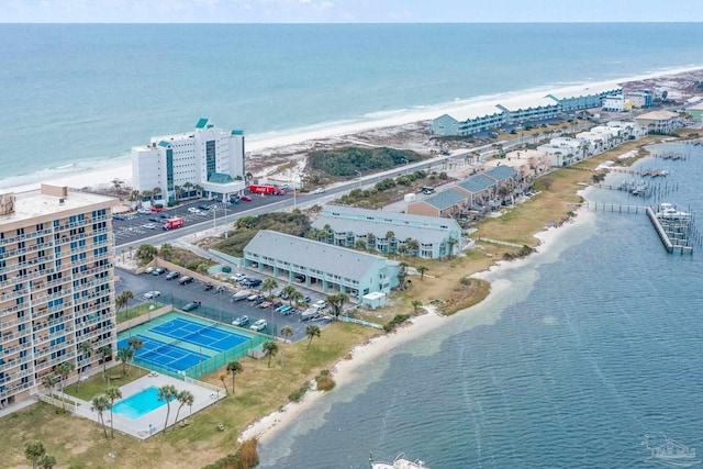 birds eye view of property with a water view and a view of the beach