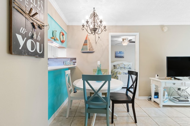 tiled dining room with ceiling fan with notable chandelier and ornamental molding