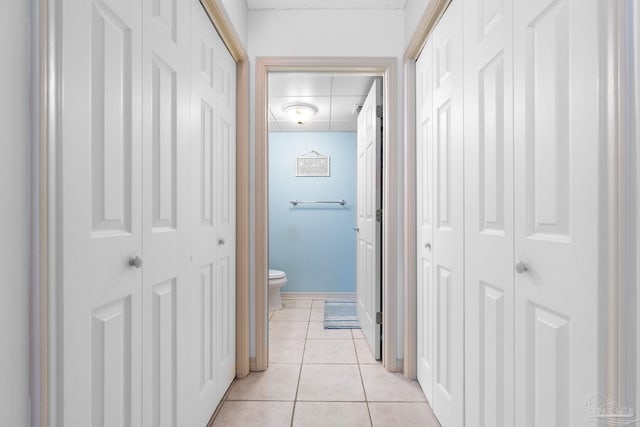 hall with light tile patterned floors