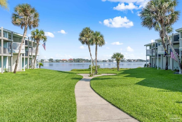 view of home's community featuring a yard and a water view