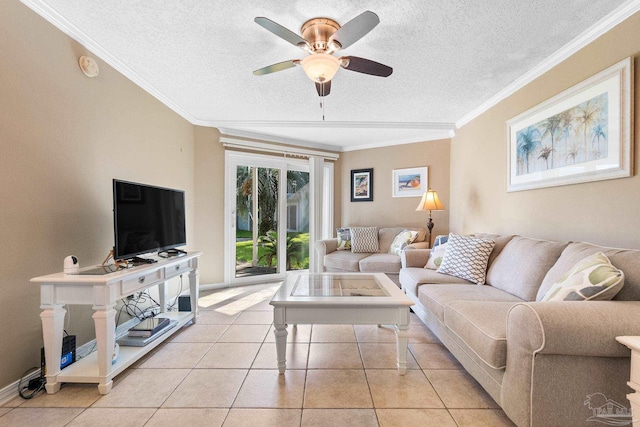 living room with a textured ceiling, ornamental molding, light tile patterned floors, and ceiling fan